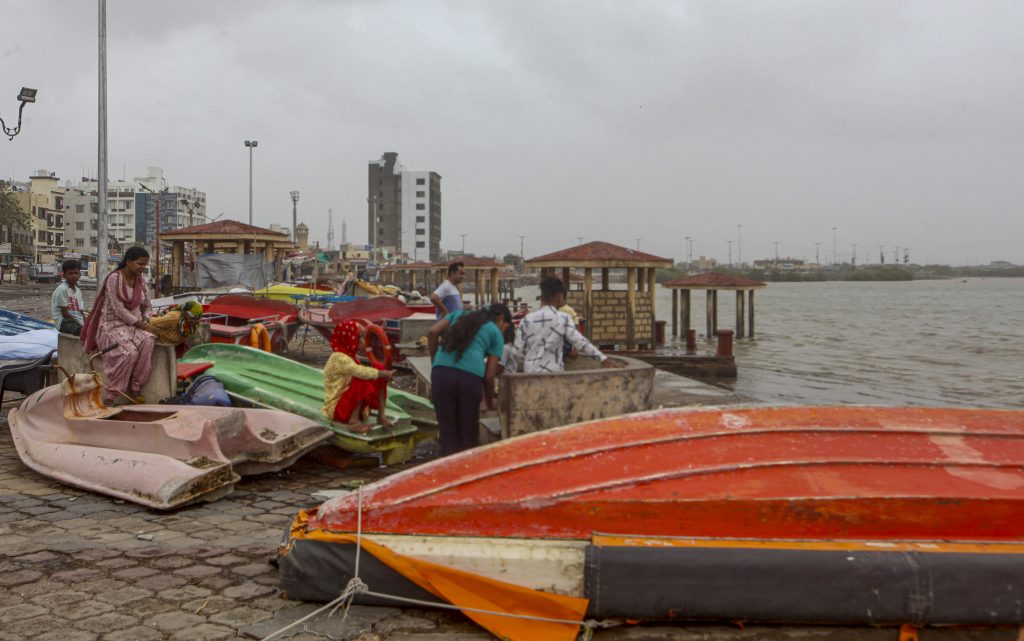 Dwarka: Locals with their fishing boats anchored along the coastline ahead of the landfall of Cyclone Biparjoy, in Dwarka, Thursday