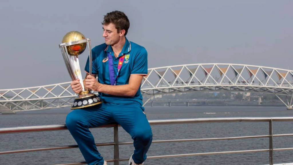 Cummins poses with the World Cup on a cruise boat in Sabarmati