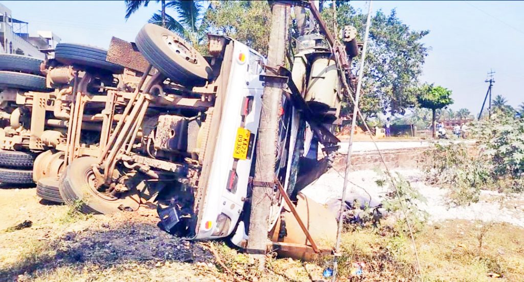 A truck carrying gravel hit a roadside transformer and overturned