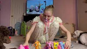 A young girl who sleeps in a cradle continues to play with toys throughout the day