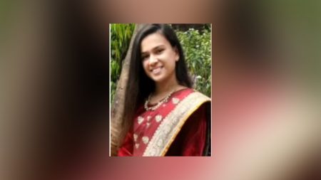 A young woman who was carrying a pet dog died after falling from the terrace